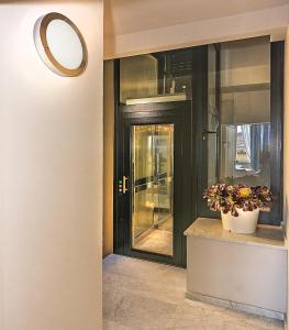 a hallway with a black door and a potted plant at Il Forte di Monic in Forte dei Marmi +26 photos
