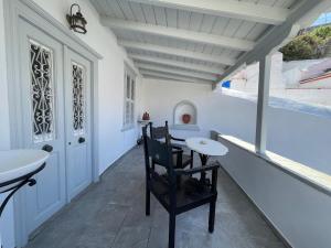 a bathroom with a table and a chair and a sink at Lemon House in Hydra