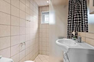 a white bathroom with a sink and a shower at 0185-Romo-Rabjergvej-82 in Høm +14 photos