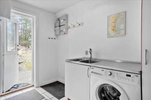 a white laundry room with a washing machine at 0185-Romo-Rabjergvej-82 in Høm