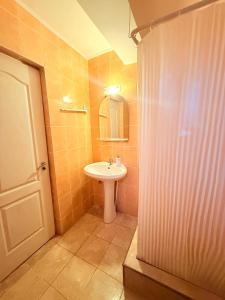 a bathroom with a sink and a toilet and a mirror at Vila Gymy in Constanţa +45 photos