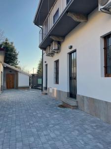 an empty courtyard next to a white building at Antico Ticino Malpensa in Lonate Pozzolo