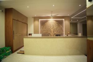 a lobby with a large picture of a tree on the wall at Manasa Comforts Boarding and Lodging Karkala in Kārkāl
