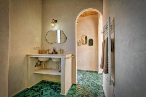 a bathroom with a sink and a mirror at La Villa DUCASSE - Piscine, pétanque, calme à Essaouira in Essaouira +54 photos