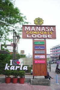 a sign for a maracasuriursurs lodge in a city at Manasa Comforts Boarding and Lodging Karkala in Kārkāl