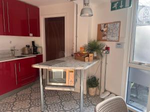 a kitchen with a table with a microwave on it at Jackie's Place in Wexford