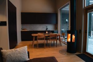 a living room with a table and a dining room at Joiku A1 Luxury Chalet in Kolari