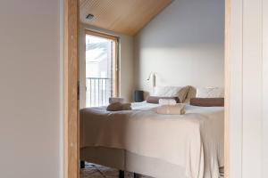 a bedroom with a large bed with a window at Joiku A1 Luxury Chalet in Kolari