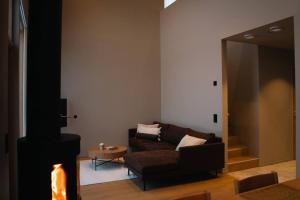 a living room with a couch and a table at Joiku A1 Luxury Chalet in Kolari