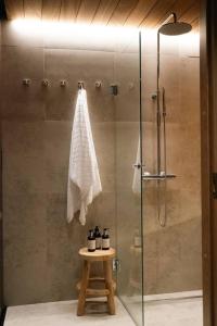 a shower with a glass door in a bathroom at Joiku A1 Luxury Chalet in Kolari +28 photos