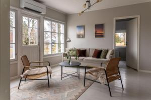 a living room with a couch and a table and chairs at Seafront Country house with jacuzzi in Salo