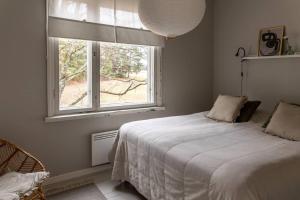 a bedroom with a bed and a window at Seafront Country house with jacuzzi in Salo
