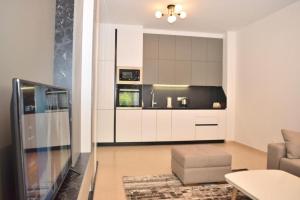 a living room with a couch and a kitchen at Garden apartment in Vala Mar in Hamallë +16 photos