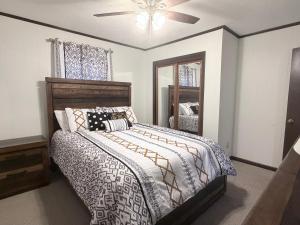 a bedroom with a bed and a ceiling fan at The Cozy Chalet in Asheville