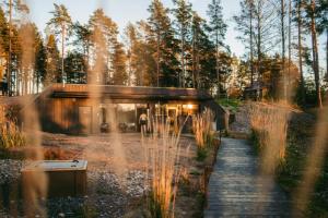 a house in the middle of a forest at Seafront Country house with jacuzzi in Salo