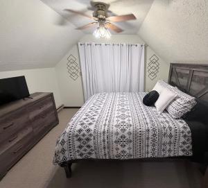 a bedroom with a bed and a ceiling fan at The Cozy Chalet in Asheville