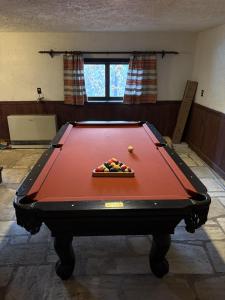 a pool table with a bowl of balls on it at Smugglers Trove a Mountain Adventure Getaway in Cambridge