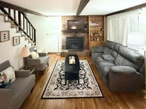a living room with a couch and a fireplace at The Cozy Chalet in Asheville