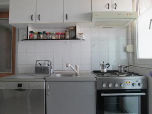 a small kitchen with a stove and a sink at Room Zox Gluten-free in Vukovar