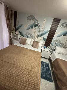 a bedroom with two beds and a mural of dolphins at Casa Concettina in Naples