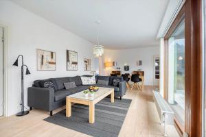 a living room with a couch and a table at 0349-Romo-Vestergade-301 in Høm