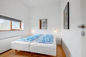 a bedroom with two beds and a window at 0349-Romo-Vestergade-301 in Høm