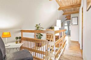 a living room with a wooden staircase in a building at 0315-Romo-Dyssebjergvej-49 in Høm
