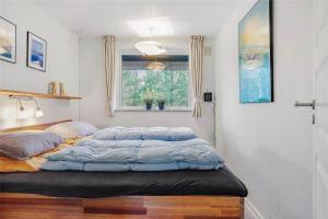 a bedroom with two beds and a window at 0315-Romo-Dyssebjergvej-49 in Høm