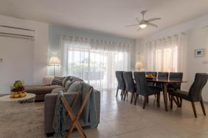a living room with a couch and a table and chairs at Villa Isla in Peyia