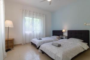 two beds in a white room with a window at Villa Isla in Peyia +72 photos