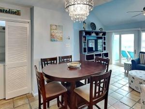 a dining room with a table and chairs at Cozy Coastal Repose in Padre Island