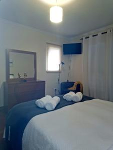 a bedroom with a bed with towels on it at Paradise Valley Ponta do Sol in Ponta do Sol
