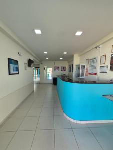 a lobby of a hospital with a blue counter at Village Hotel Belém in Belém de São Francisco