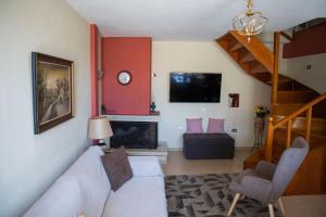 a living room with a couch and a fireplace at Το Αρχοντικό της Λενιώς in Taxiárkhis