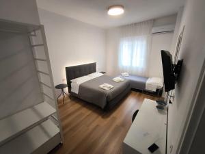 a small bedroom with a bed and a desk at Faber Home in Conversano
