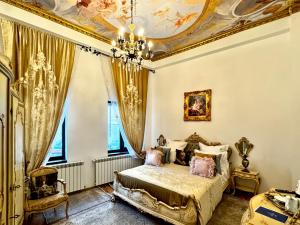 a bedroom with a bed with a gold ceiling at Chateau D'Amour Luxury Boutique in Bucharest