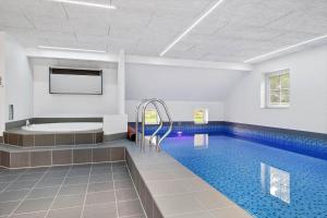 a swimming pool with a bath tub and a swimming pool at 0119-Romo-Smafolksvej-43 in Høm