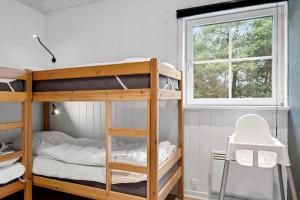 a bedroom with bunk beds and a window at 0119-Romo-Smafolksvej-43 in Høm +22 photos
