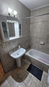 a bathroom with a sink and a bath tub at Dúplex Premium Cañada!! in Cañada de Gómez +4 photos