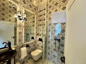 a bathroom with a toilet and a sink at Chateau D'Amour Luxury Boutique in Bucharest +54 photos