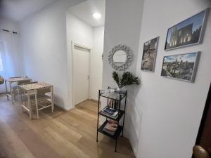 a room with a table and a mirror on a wall at Le Camere di Don Nicó in Tarquinia