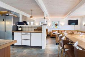 a kitchen and dining room with a table and chairs at 0499-Romo-Vestergade-29 in Høm