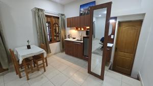 a kitchen with a table and a small table and a mirror at Los balcones in Sucre