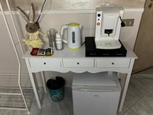 a white desk with a sewing machine on it at Casa Concettina in Naples