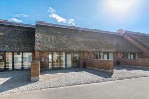a large brick building with a roof at 1170-Romo-Gulirisvej-170 in Høm