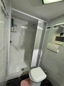 a bathroom with a shower and a toilet and a tub at Casa Concettina in Naples