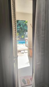 an open door with a view of a pool at Só Alegria in Paulista +74 photos