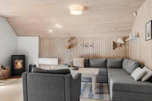 a living room with a couch and a fireplace at 0019-Romo-Moritzvej-12 in Høm