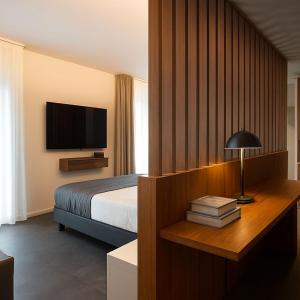 a hotel room with a bed and a television at Hotel Miramare in Sottomarina