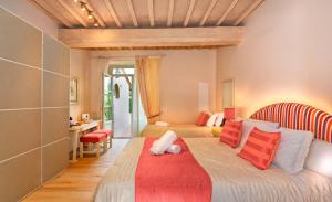 a bedroom with a large bed with red and white pillows at B&B Borgo di Pratavecchie in Migliarino